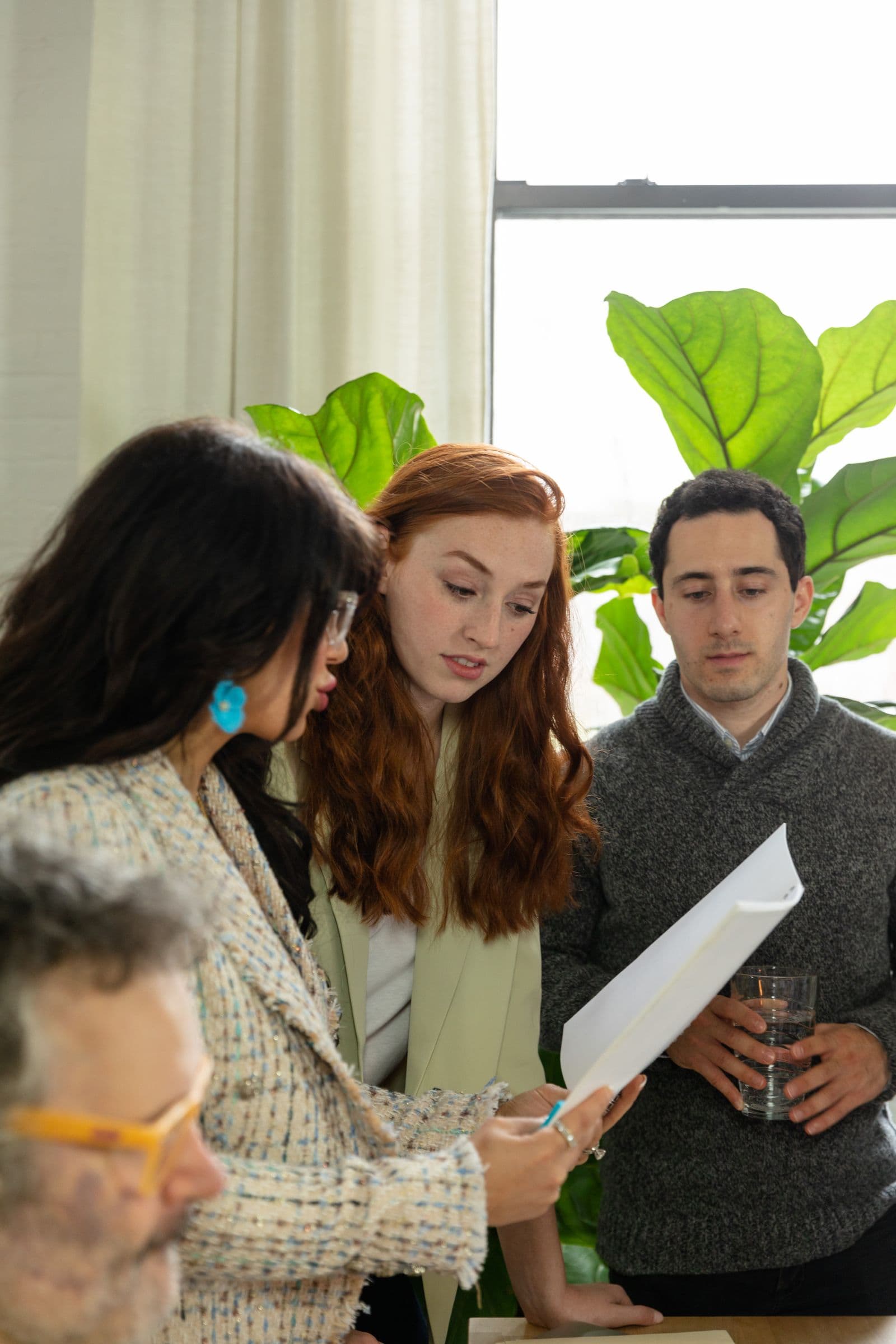 Business professionals reviewing documents together around a table